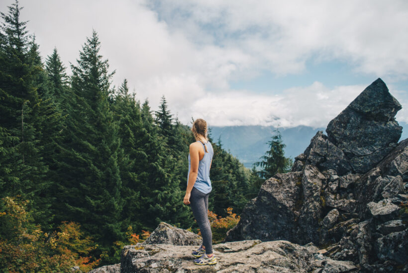 A woman explores the Pacific Northwest with rewards she earned with a credit union credit card.